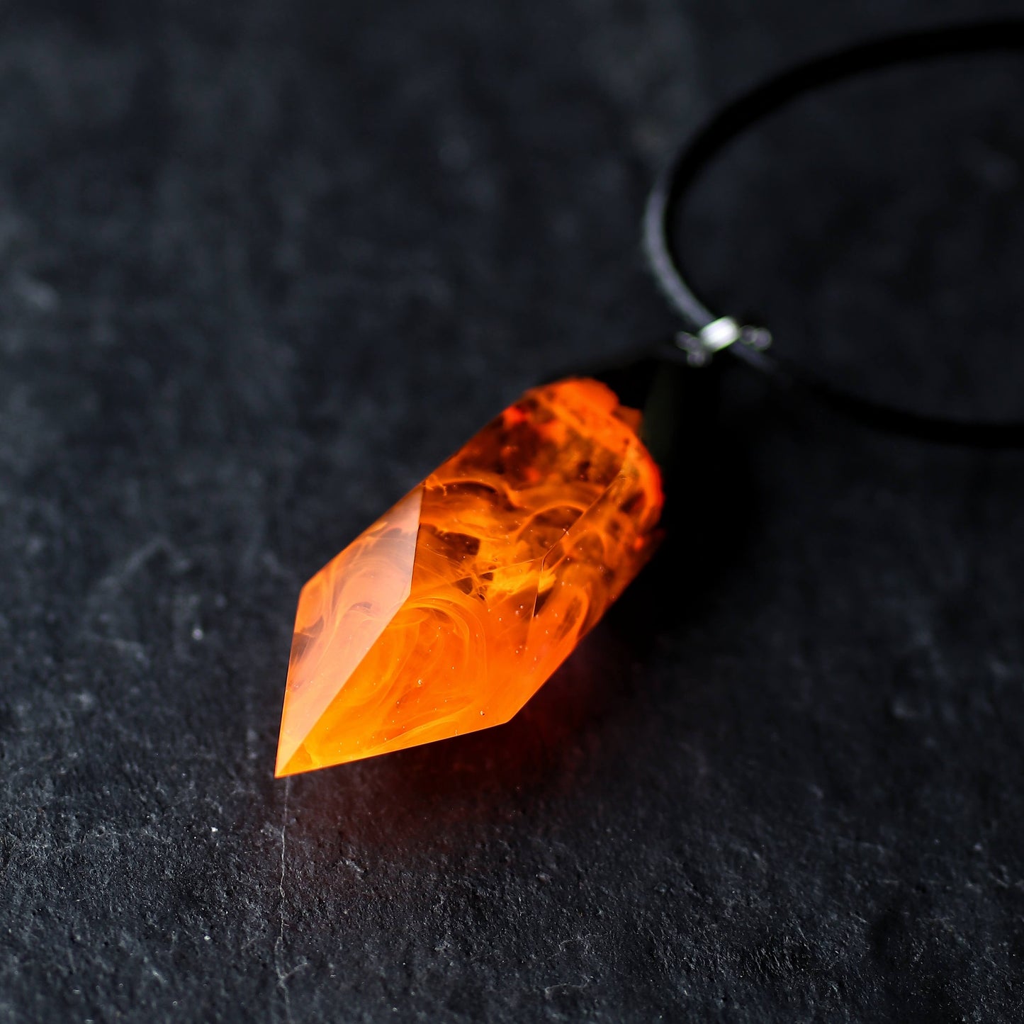 Wood resin necklace with orange fire design inside a Crystal-shaped pendant, handmade flame jewelry on black cord