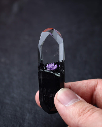 Hand holding handmade resin and wood USB stick with flower