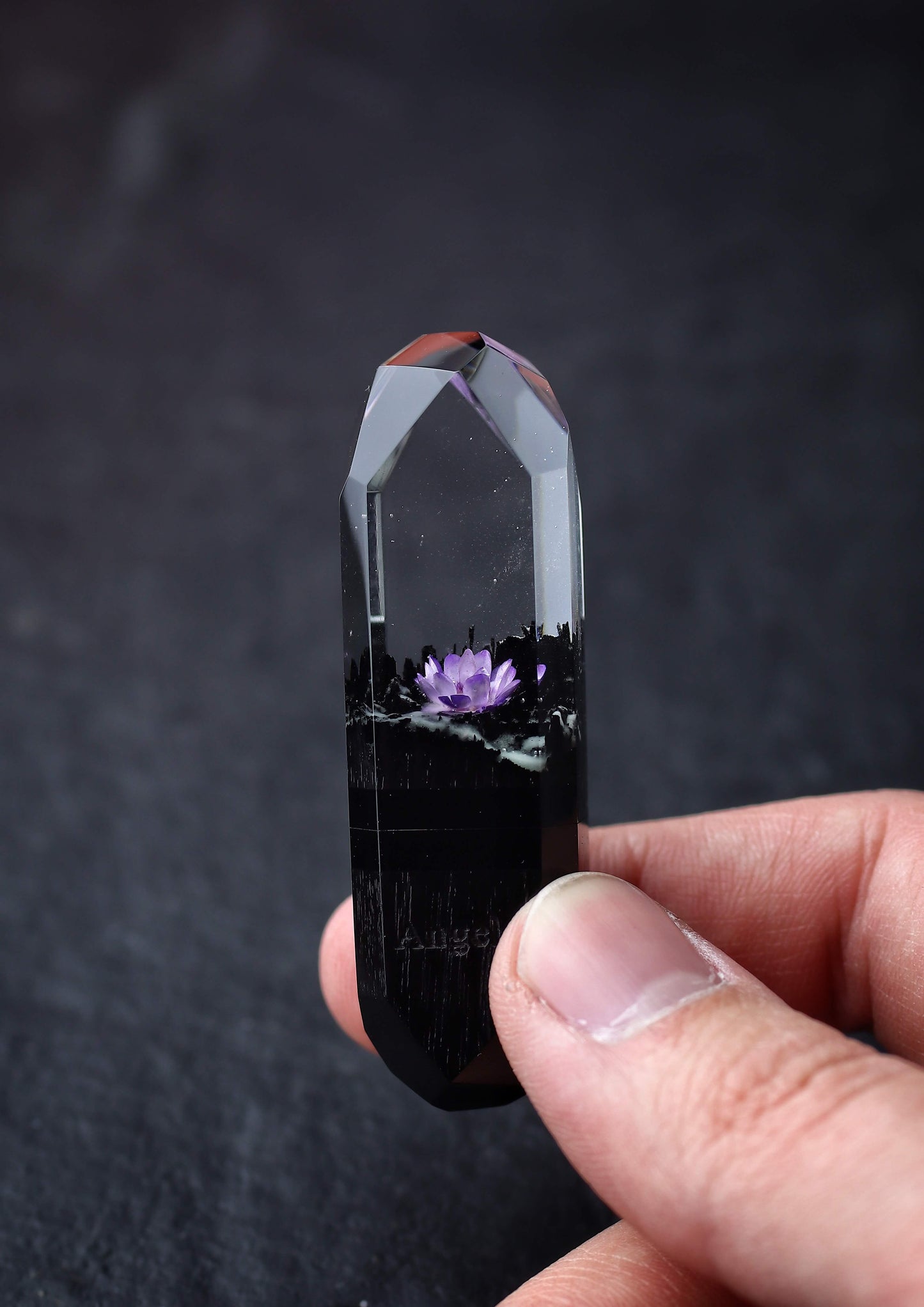 Hand holding handmade resin and wood USB stick with flower