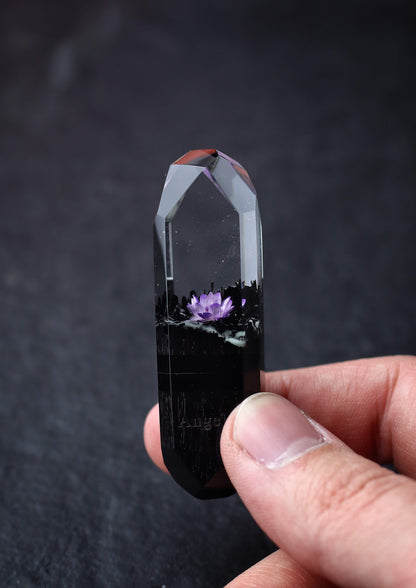 Hand holding handmade resin and wood USB stick with flower