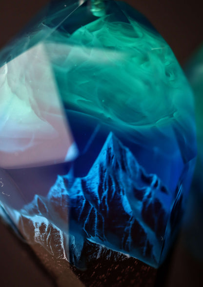 Pair of resin wood heart pendants glowing in blue northern lights style