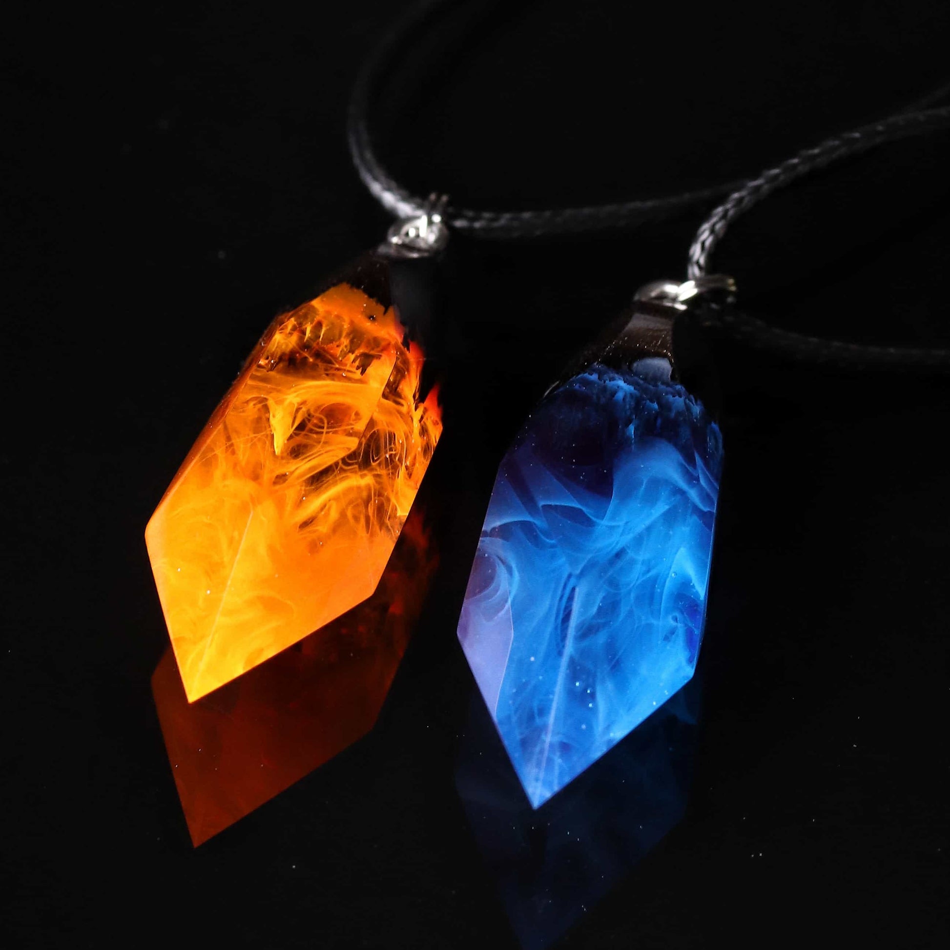 Wood resin necklace with orange fire design inside a Crystal-shaped pendant, handmade flame jewelry on black cord