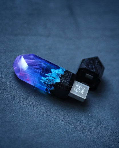 Handmade resin and wood USB stick with mountain design held in hand”