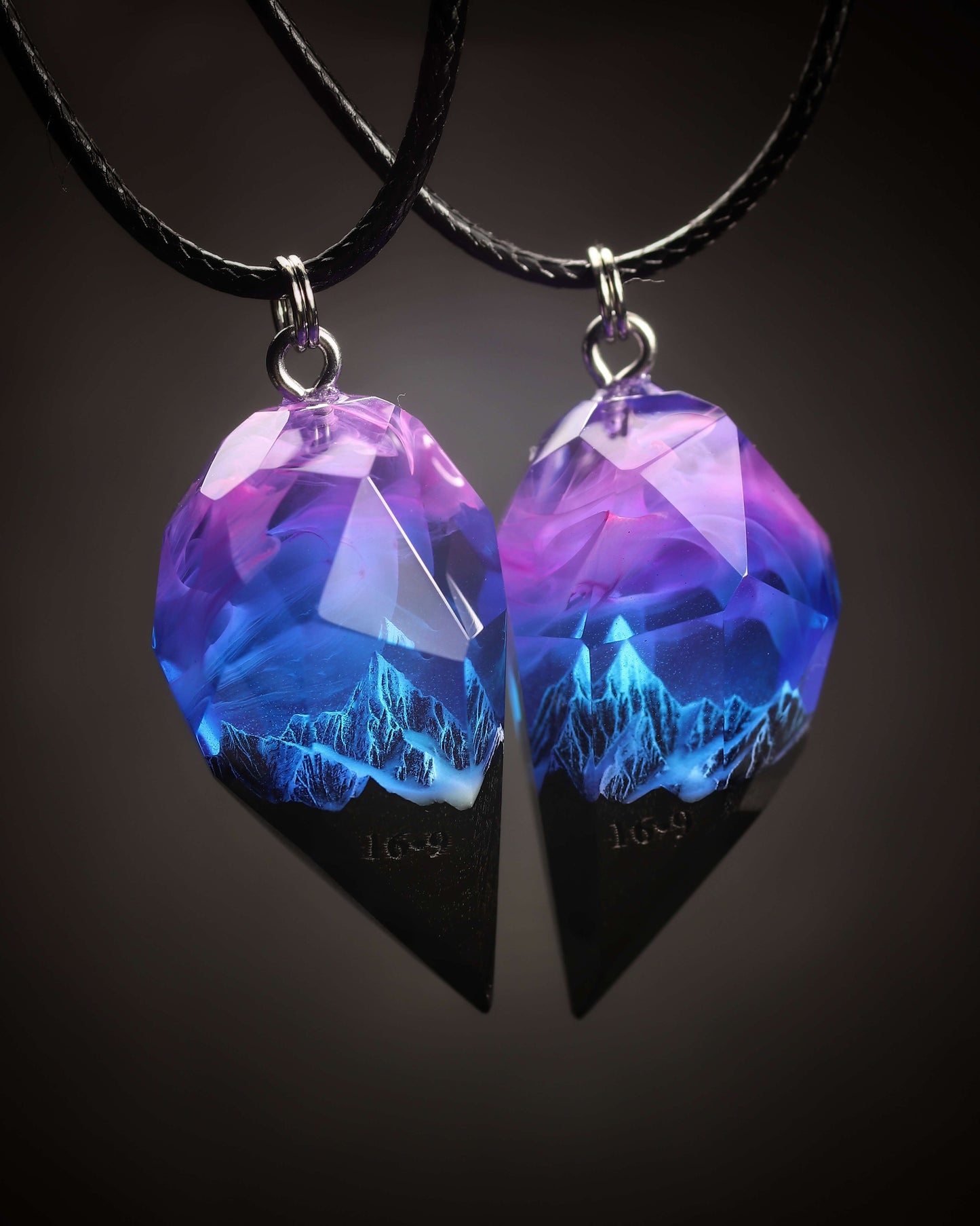 Couple resin and wood pendants with mountain design under purple sky