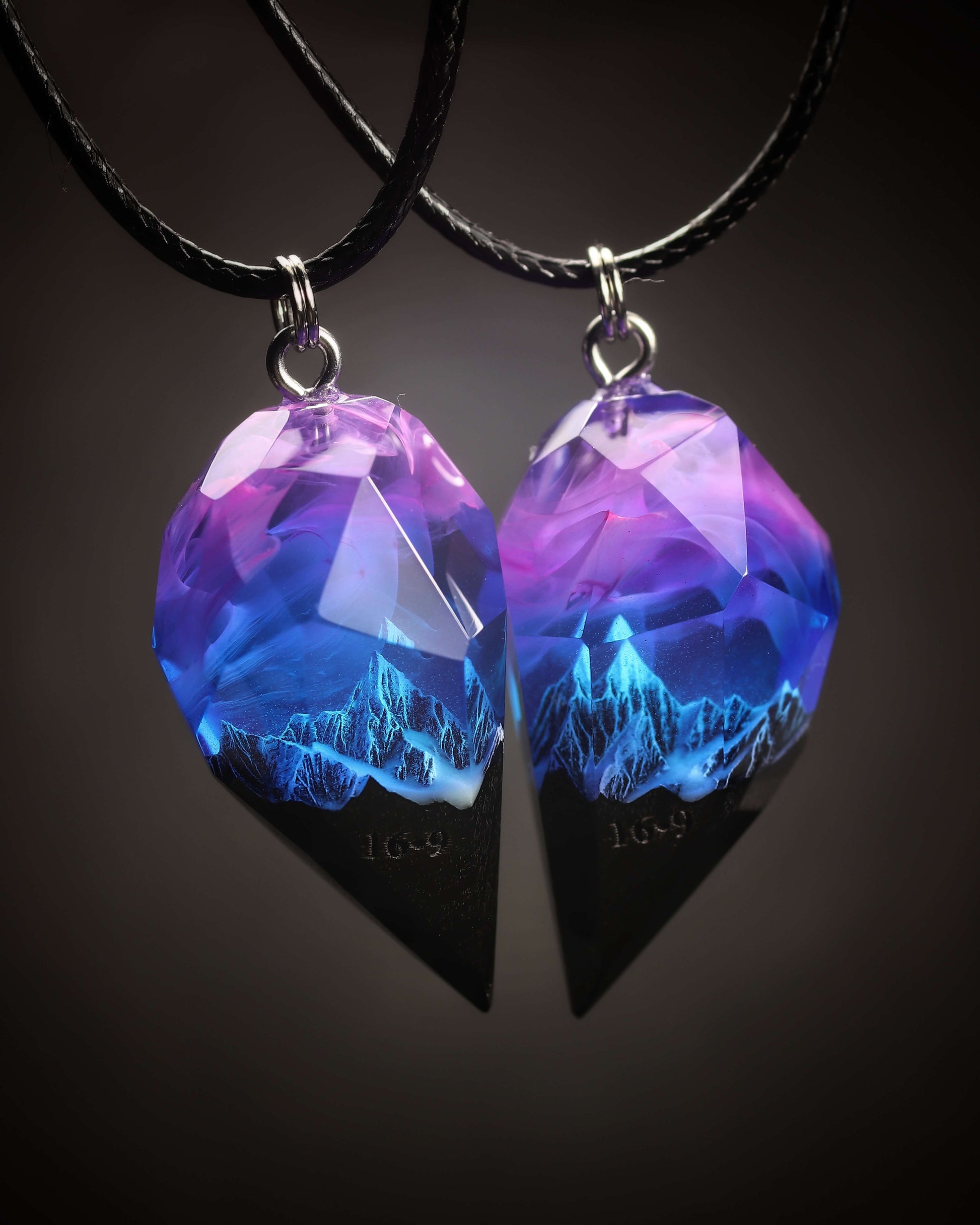 Couple resin and wood pendants with mountain design under purple sky