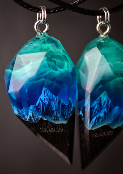 Couple resin and wood pendants with mountain landscape design