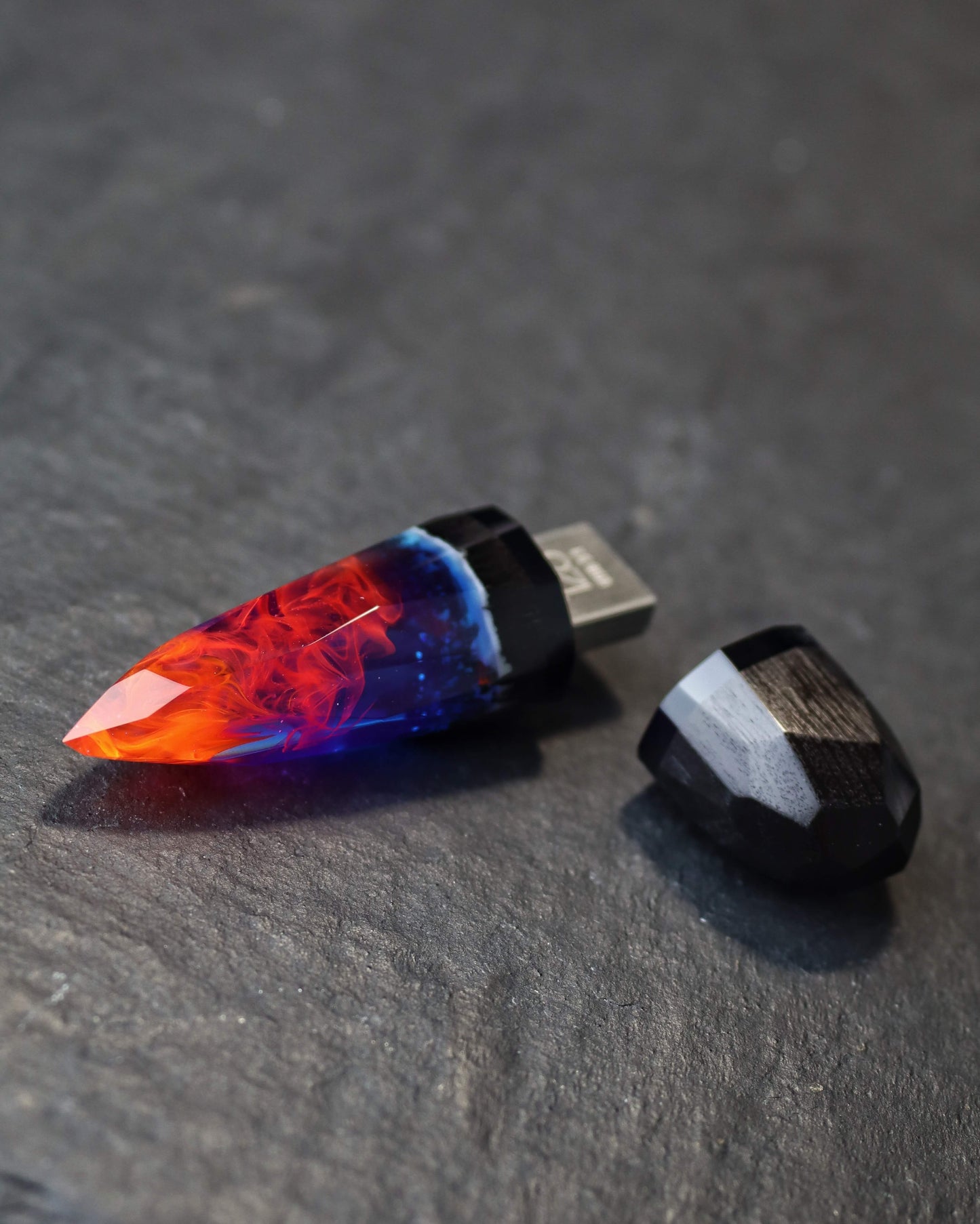 Crystal-shaped resin pendants with flame effect and dark wood base