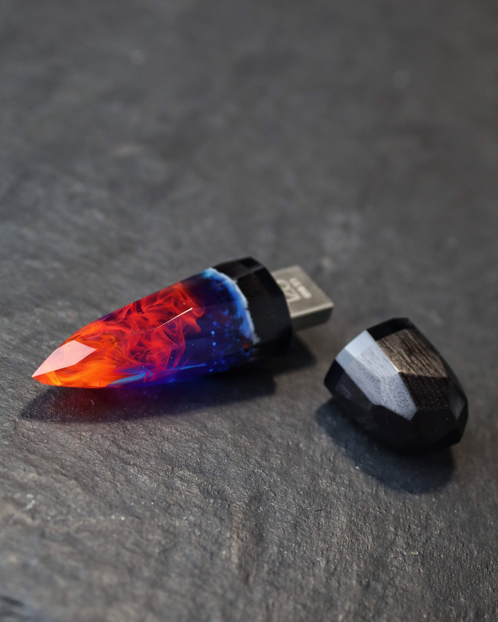 Crystal-shaped resin pendants with flame effect and dark wood base