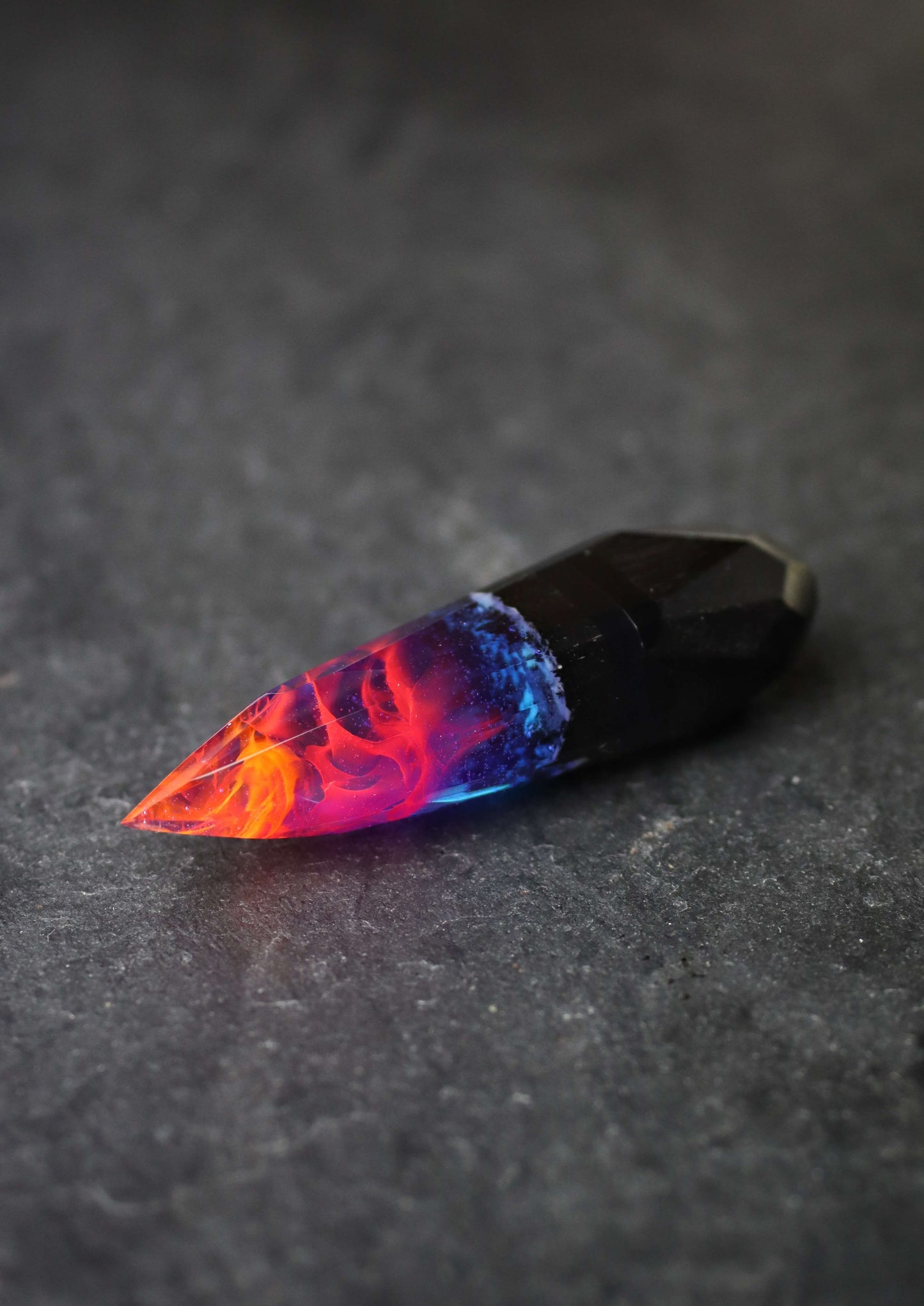 Crystal-shaped resin pendants with flame effect and dark wood base