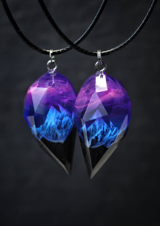 Pair of handmade resin and wood couple pendants glowing purple and blue