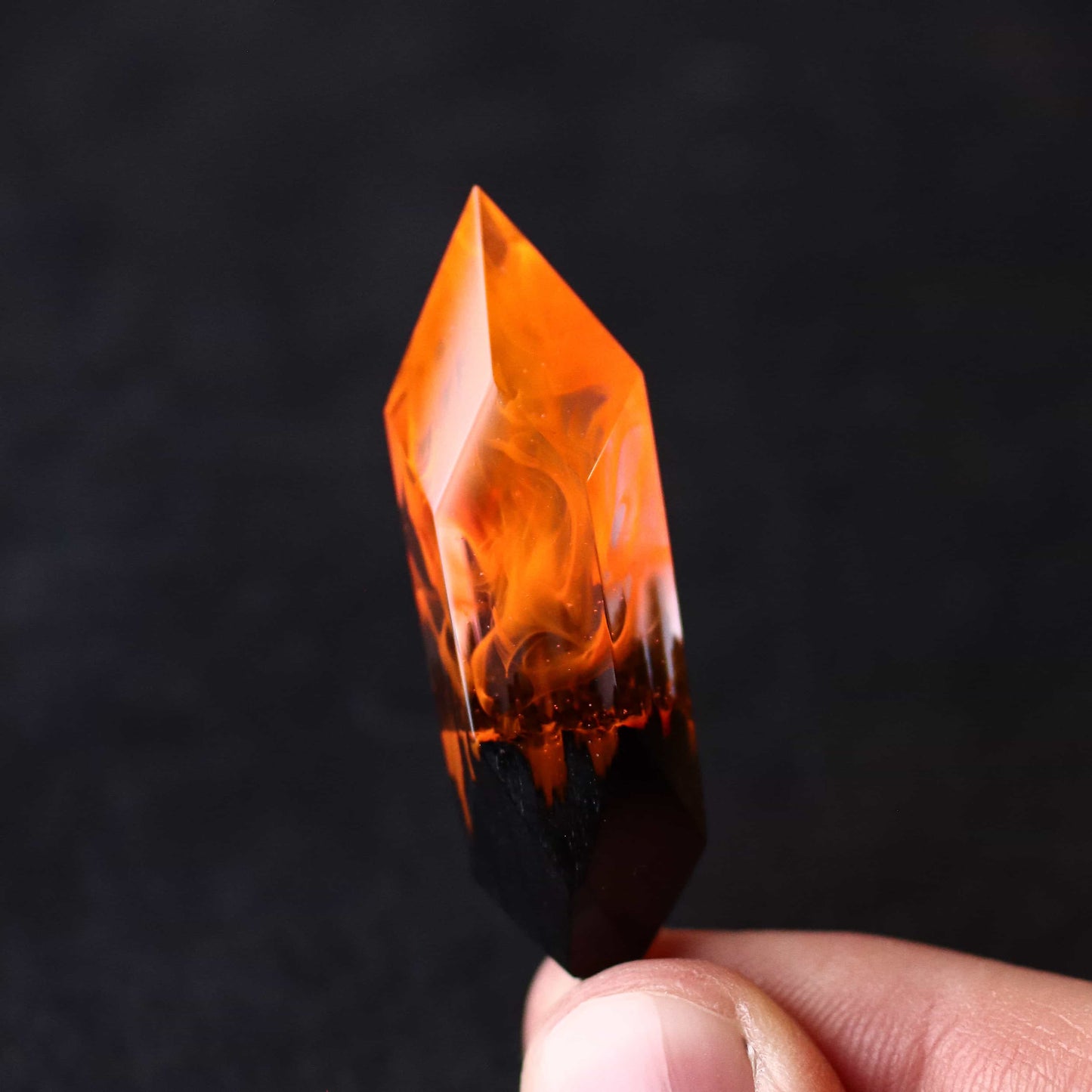 Wood resin necklace with orange fire design inside a Crystal-shaped pendant, handmade flame jewelry on black cord