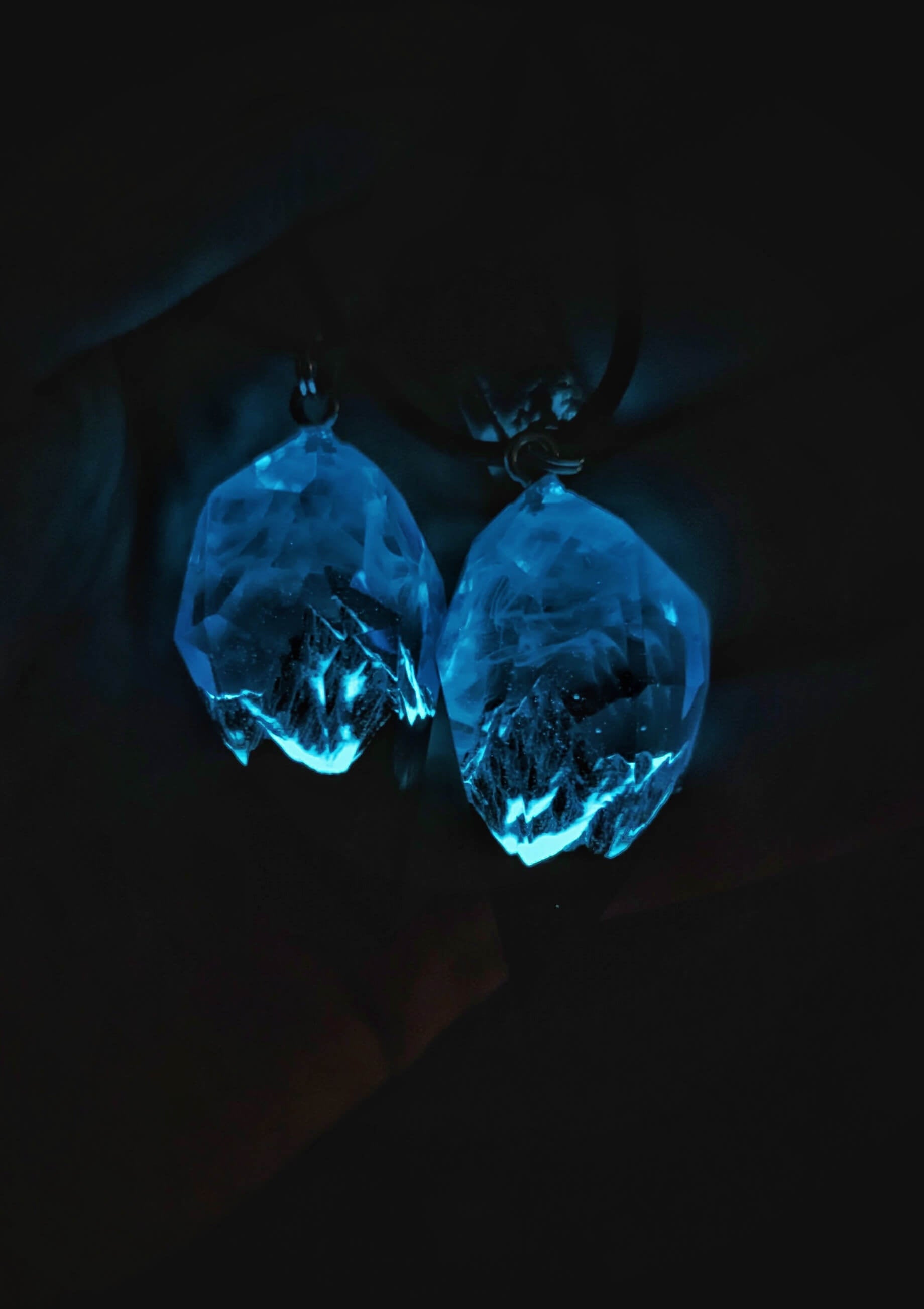 Couple resin and wood pendants with mountain design under purple sky glows in the dark