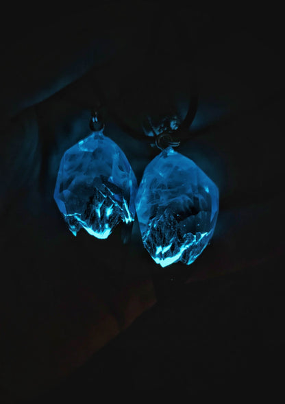 Couple resin and wood pendants with mountain design under purple sky glows in the dark
