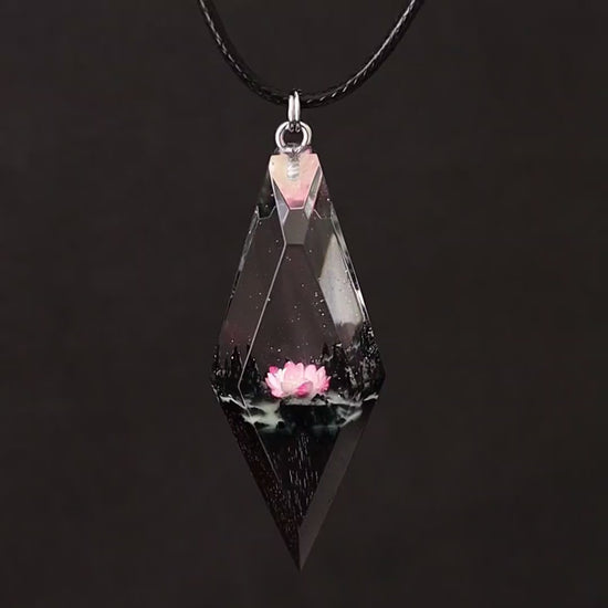 Wood resin necklace with pink lotus flower inside a rhombus crystal-shaped pendant, handmade jewelry on black cord