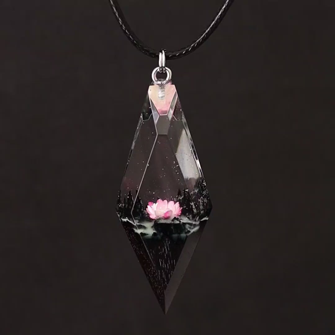 Wood resin necklace with pink lotus flower inside a rhombus crystal-shaped pendant, handmade jewelry on black cord
